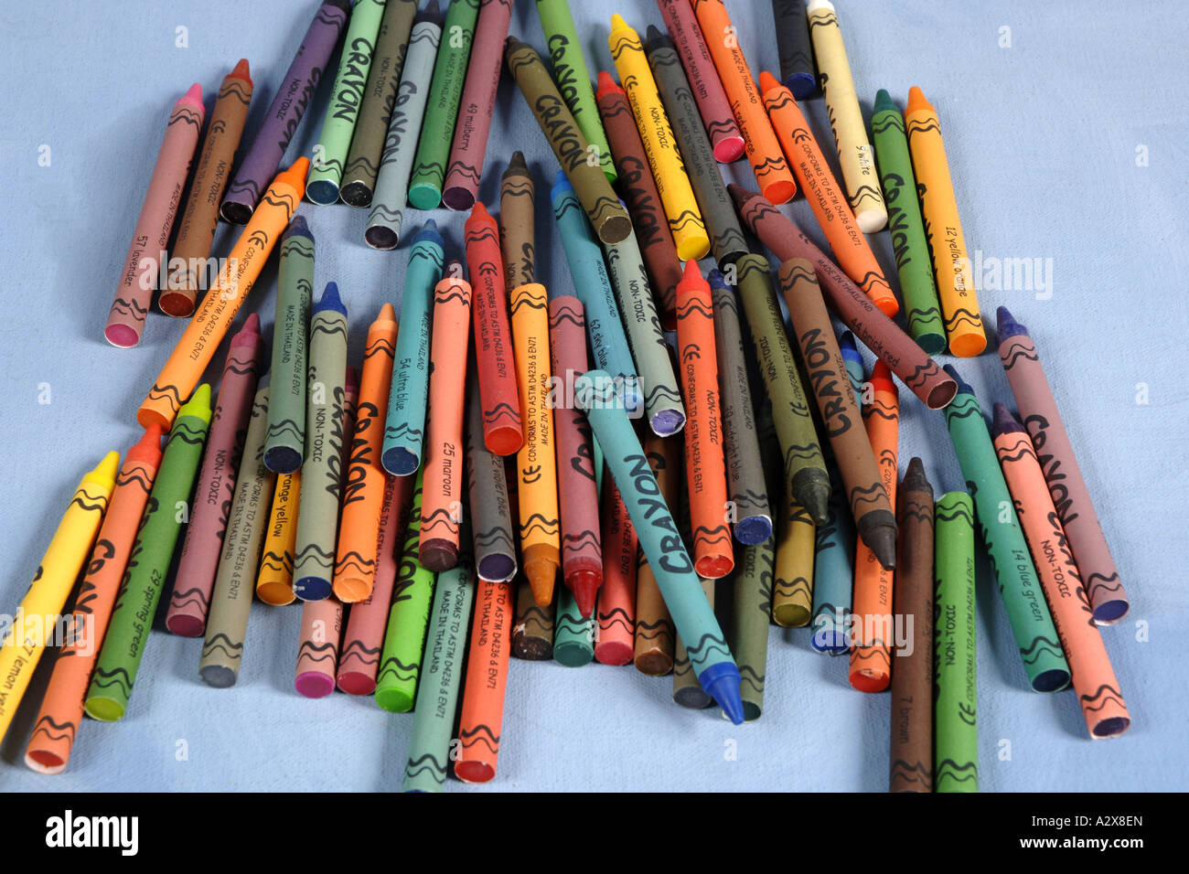 Collection of multi colored Wax Crayons against a blue background Stock ...