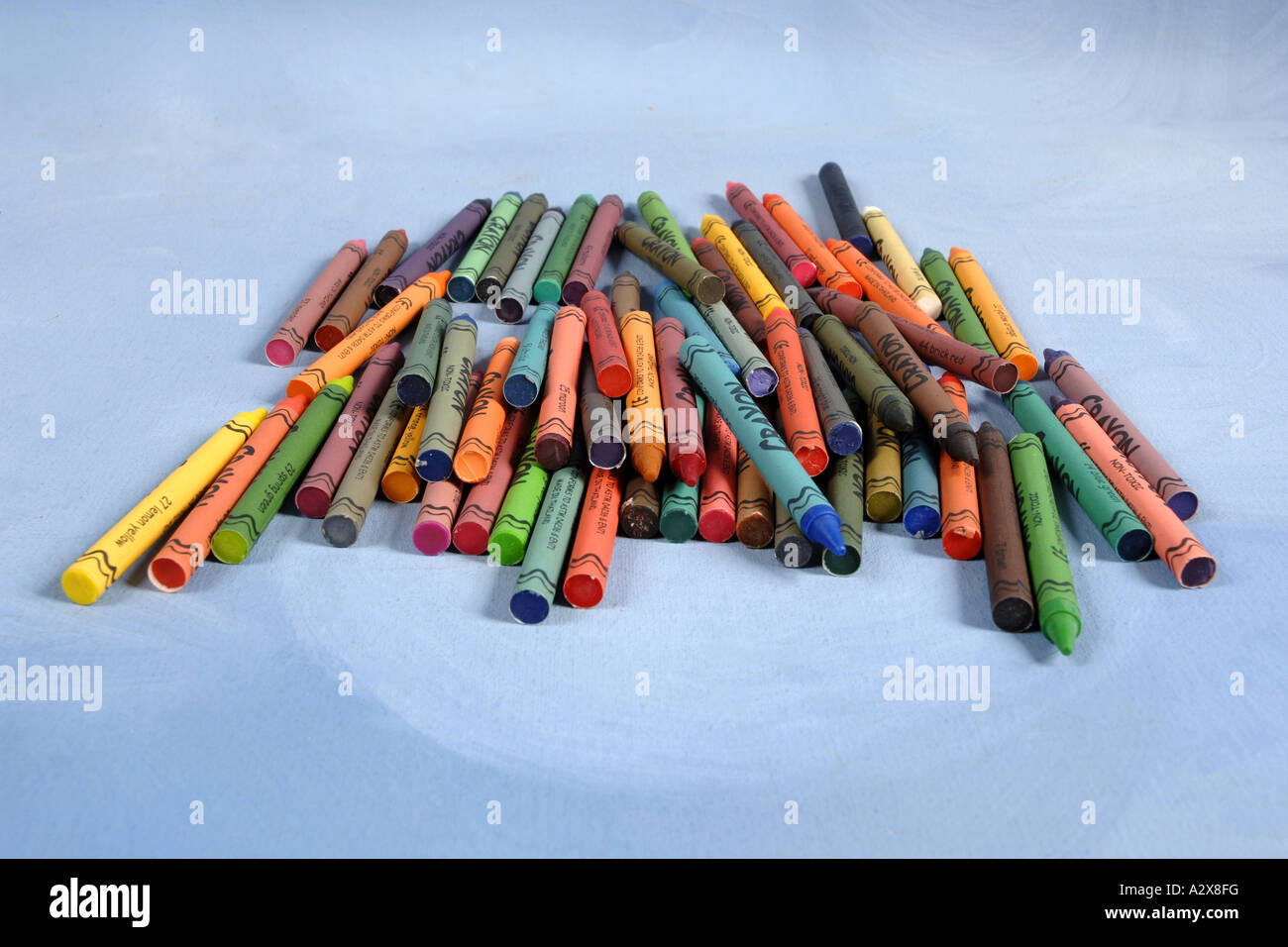 Collection of multi colored Wax Crayons against a blue background Stock ...