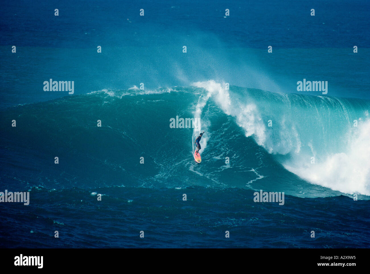 Surfing man riding on crashing wave. Stock Photo