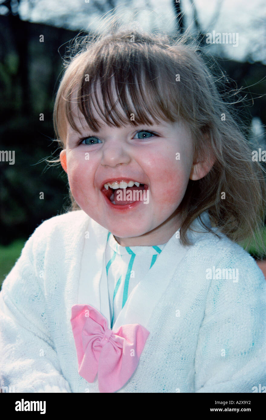 Close up of happy little girl outdoors in garden Stock Photo - Alamy