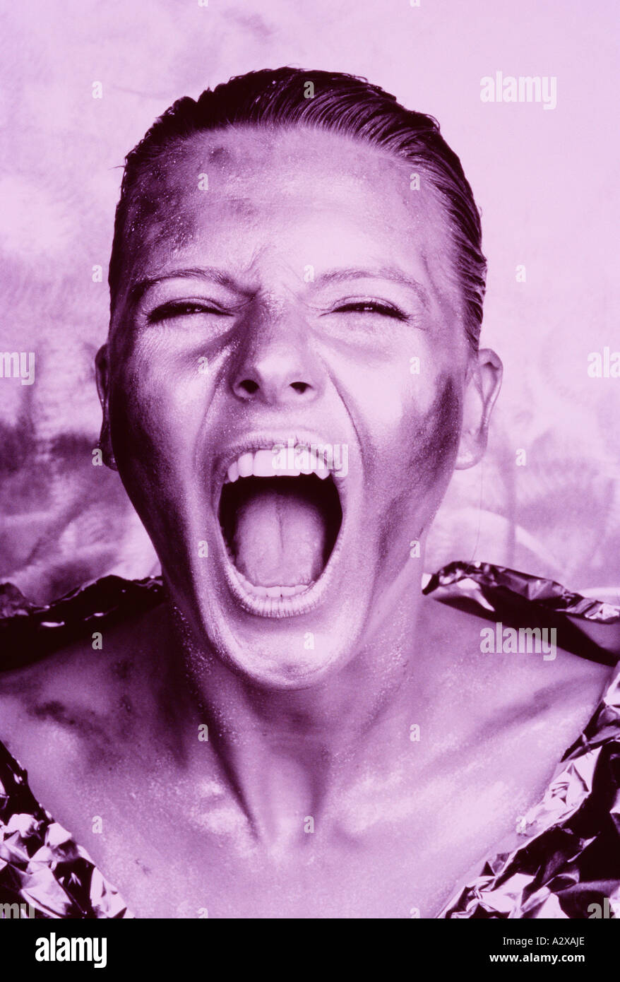 Close-up of young woman's face with screaming, shouting ...