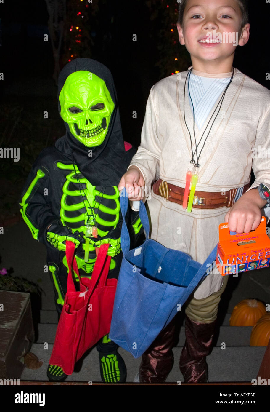 Halloween trick or treaters in skeleton and explorer costumes with