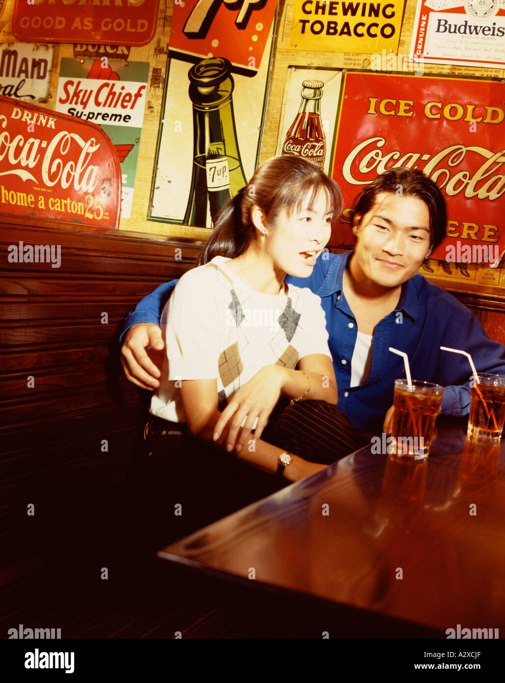 Young Asian couple in bar. Stock Photo