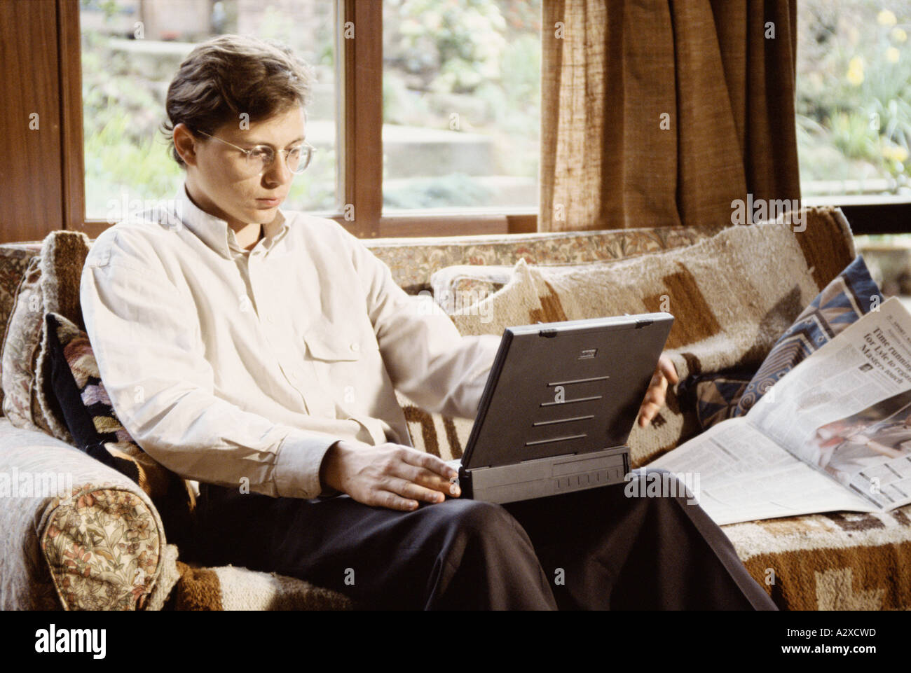 Young businessman working at home on laptop computer. Stock Photo