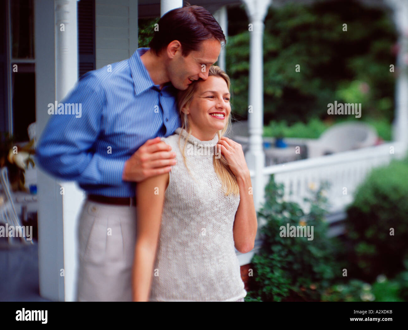 Young couple standing outside front porch of home Stock Photo - Alamy