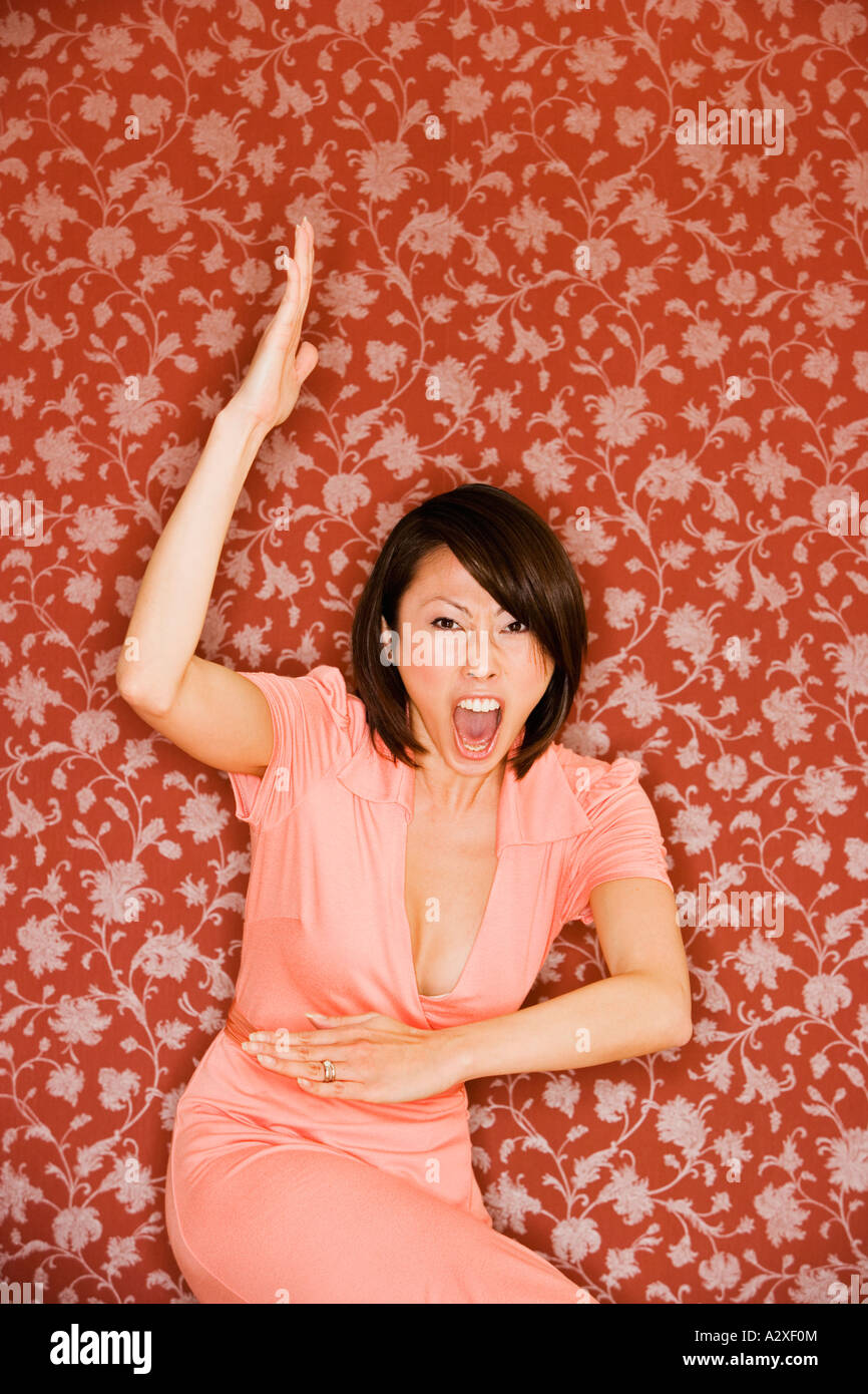Asian woman in dress doing martial arts move Stock Photo