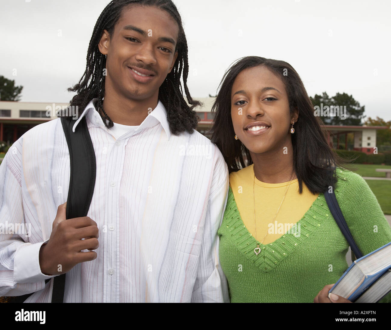 Young African couple smiling with school books Stock Photo - Alamy
