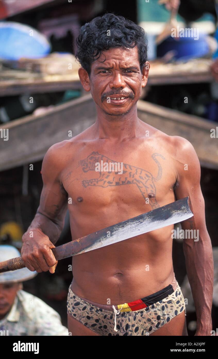 ASIA MYANMAR BURMA Moken Tribe sea gypsy holding fish cleaning knife in