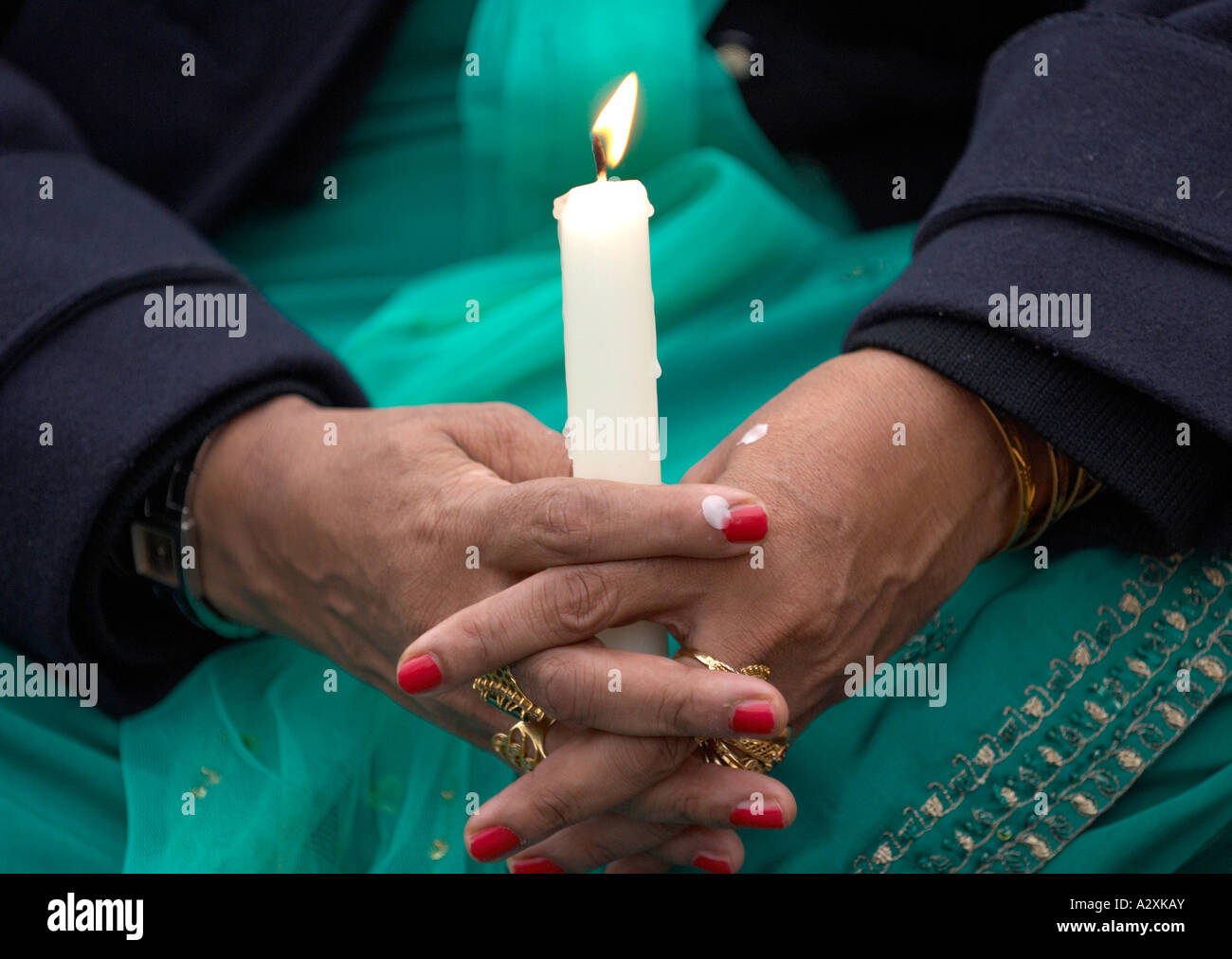 Sikh woman holding a lit candle Stock Photo