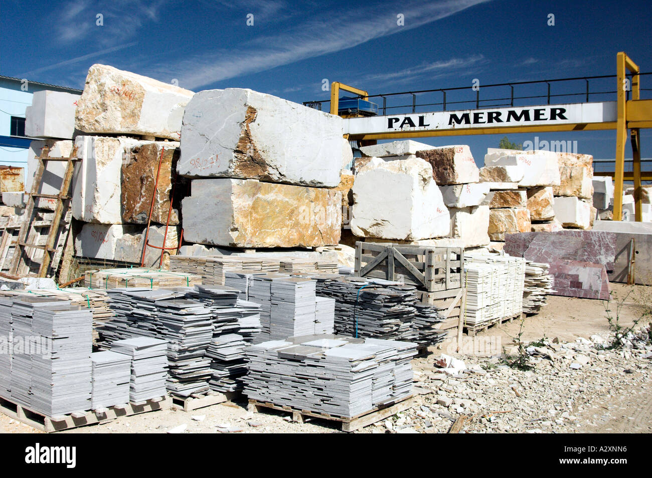 Raw marble slabs from nearby quarries is prepared for shipping by large
