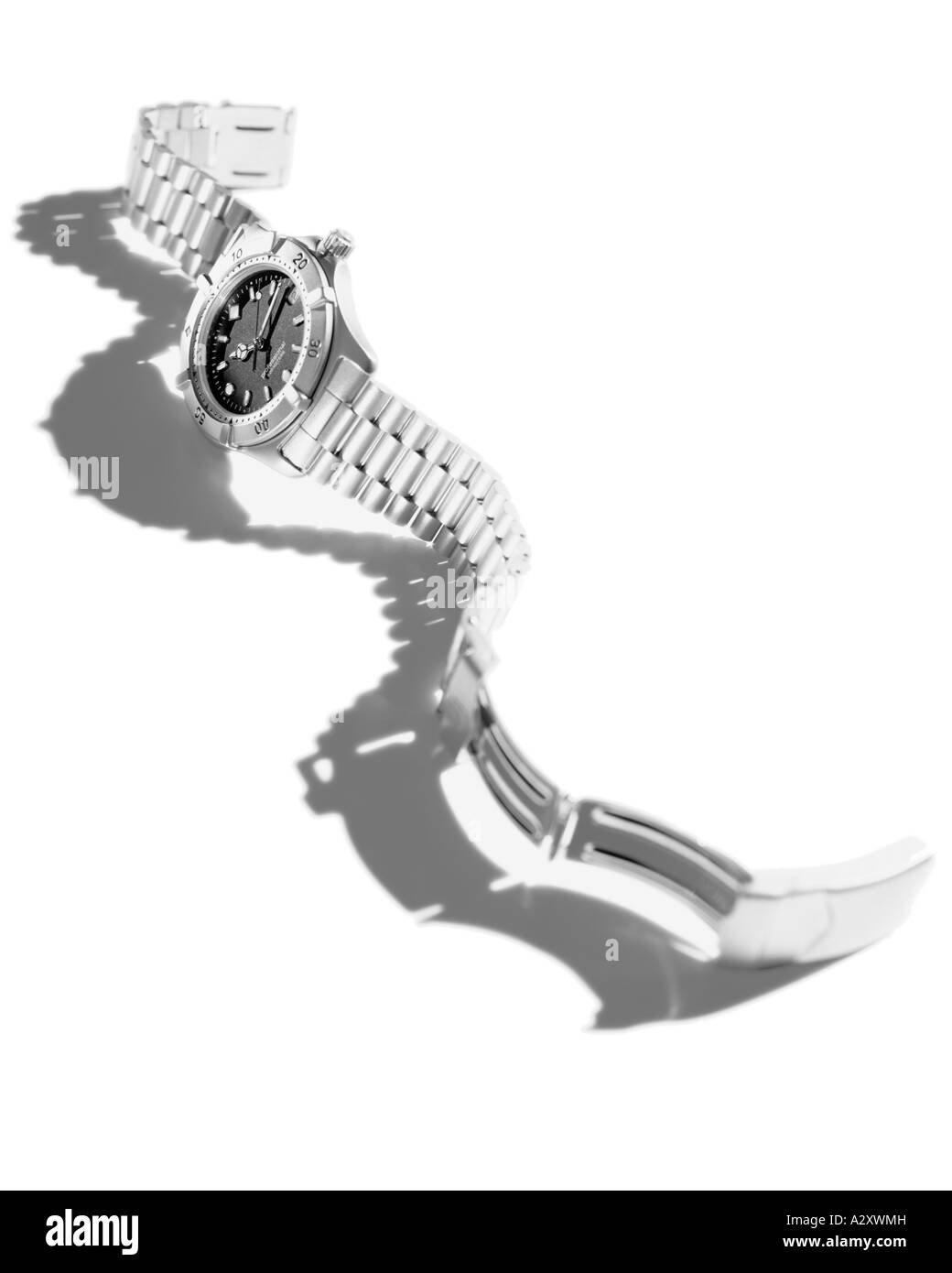 Stainless still silver watch laying on surface with band unclasped Stock Photo