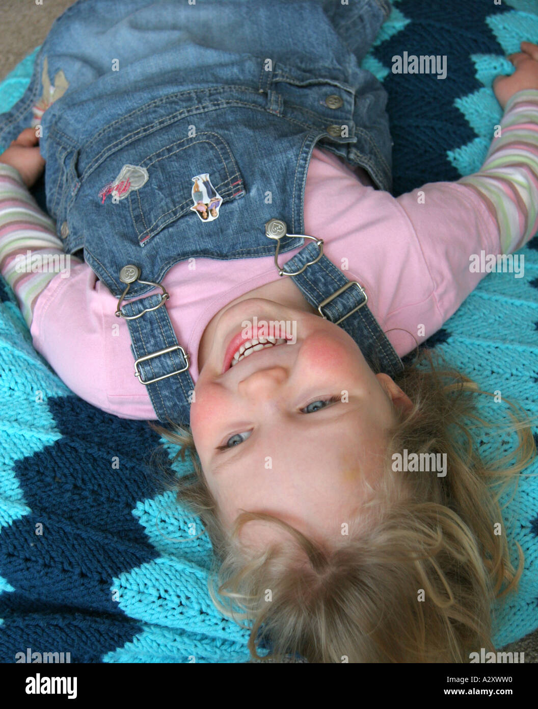 young girl lying on her back laughing Stock Photo - Alamy