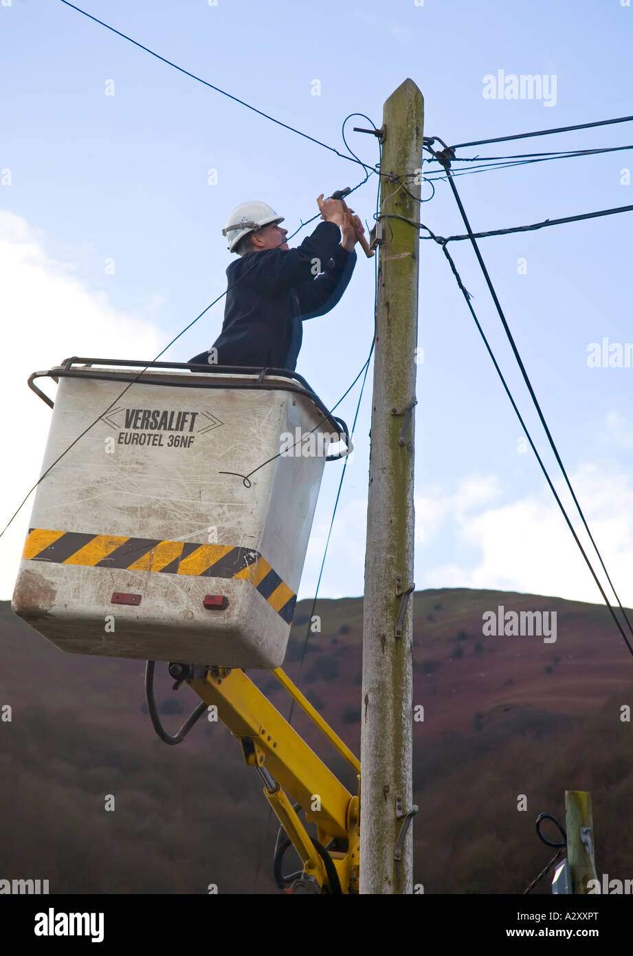 Engineer working on telephone lines using a mechanical lift Abergavenny