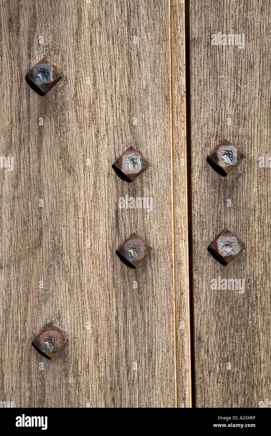 Traditional hand made nails in oak door Usk castle Wales UK Stock Photo