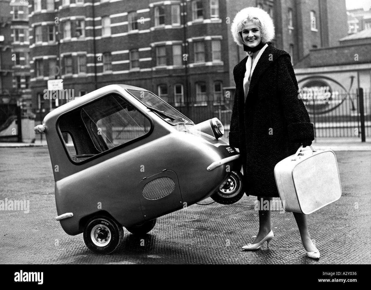 Economic realities in Europe forced car makers to think lean Inexpensive small cars and covered scooters were popular The Peel P 50 was presented at the 1962 London Motor Show It claimed to be the world s smallest and cheapest car Karen Birch finds it comfortable and easy to handle Die wirtschaftlichen Vorzeichen in Europa zwingen die Automobilhersteller in kleineren Dimensionen zu denken Populaer sind guenstige Kabinenroller und Kleinwagen Auf der Londoner Automobilausstellung 1962 praesentiert sich der Peel P 50 Er ruehmt sich der kleinste und billigste Wagen der Welt zu sein Karen Birch Stock Photo