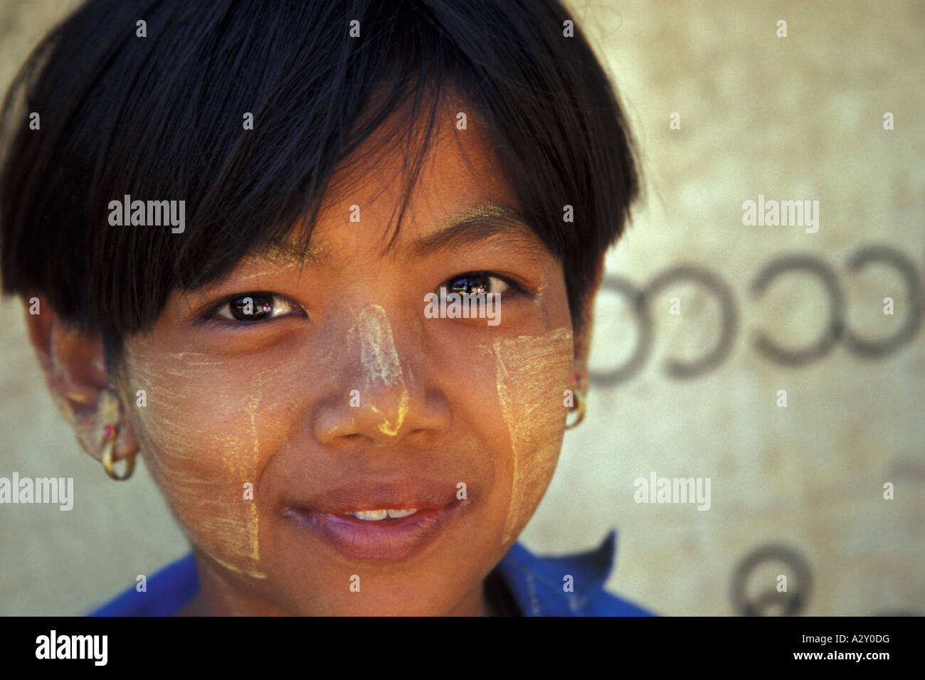 Girl of Myinkaba Village and Burmese Writing, Bagan, Myanmar Stock Photo