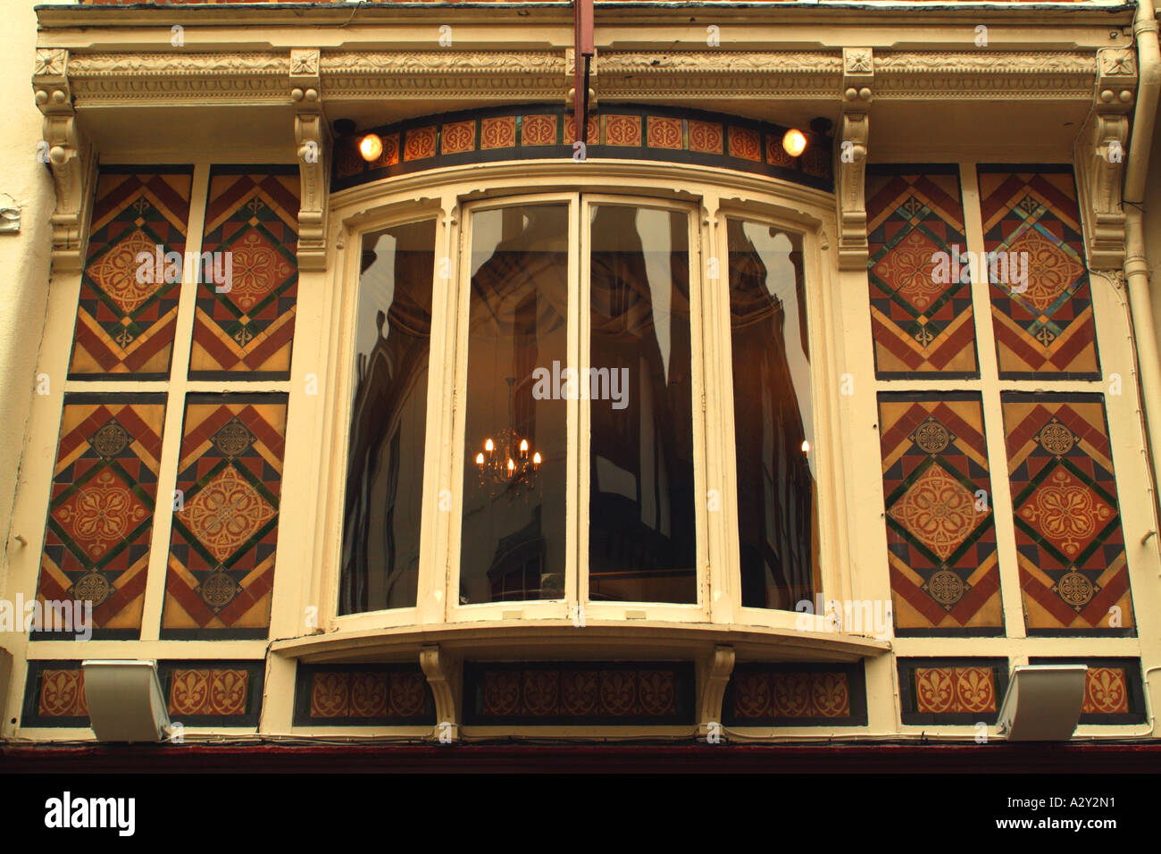 Detail of 19th century tiles on the front of the building at 10