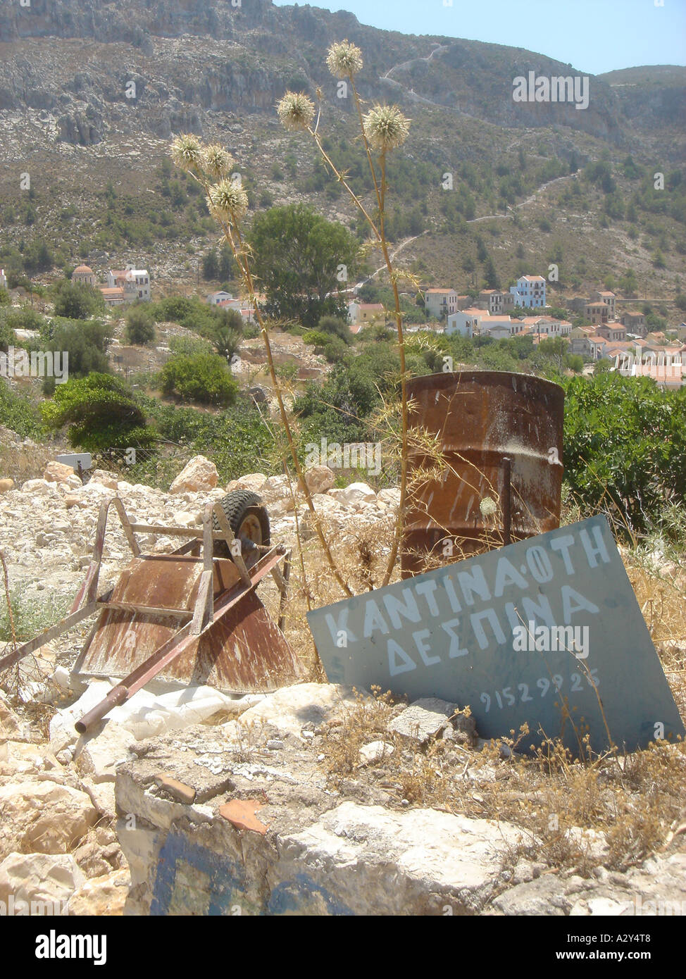 Wheelbarrow and signboard, Kastelorizo Town, Kastelorizo, Greece, July