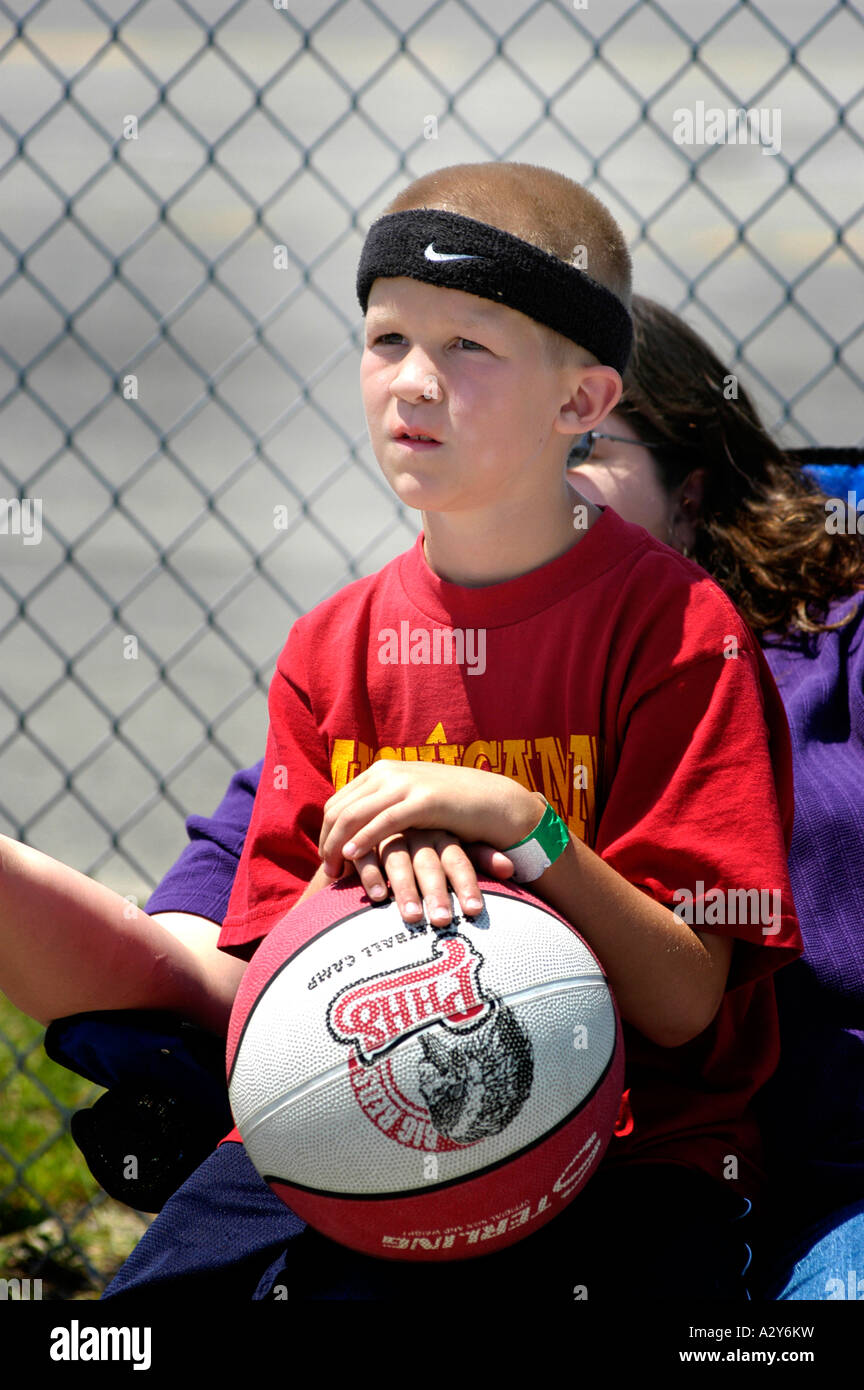 8 through 10 year old boys and girls play basketball outside in a city sponsored tournament Port