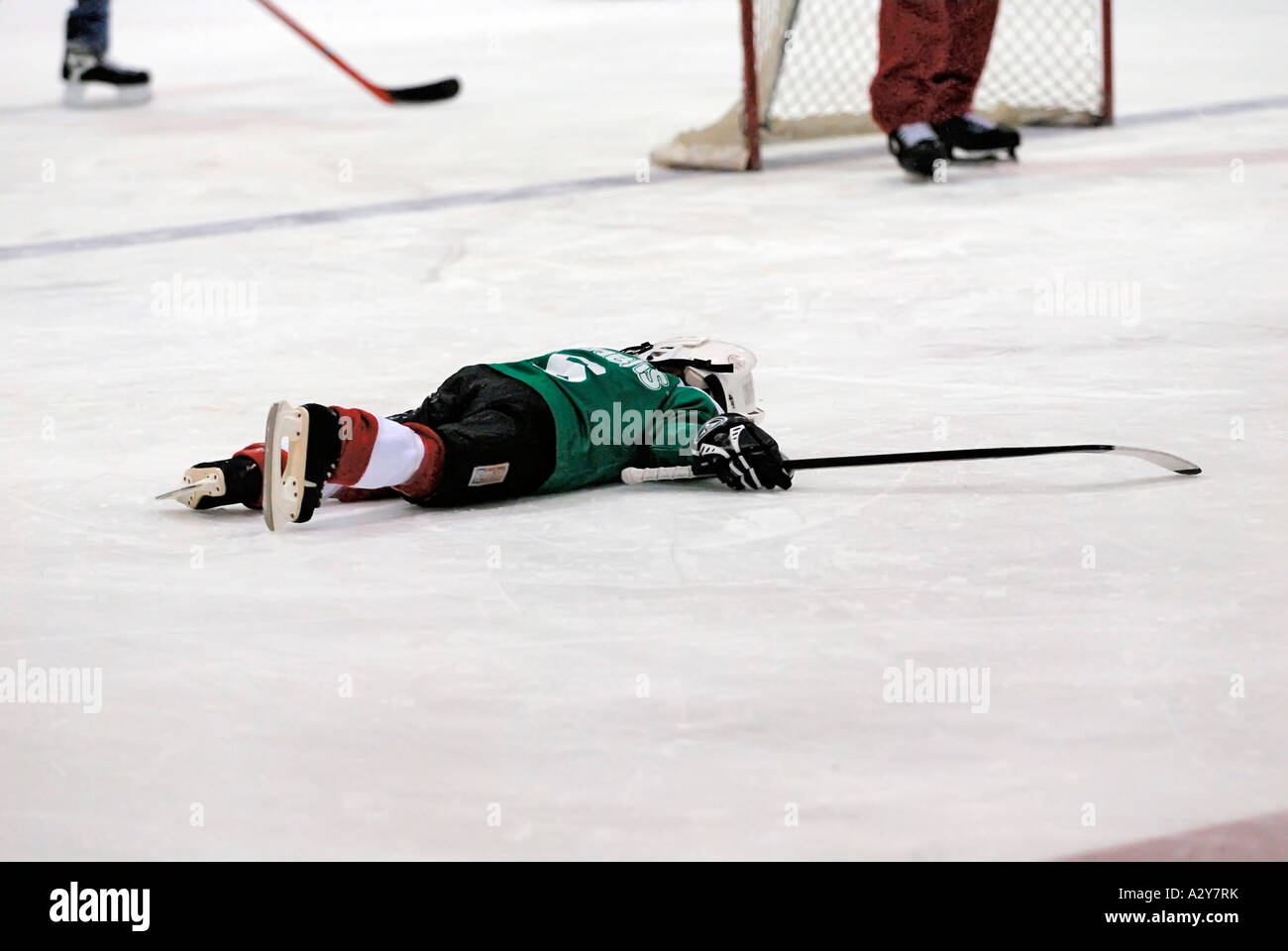 5 and 6 year old children learn how to play the game of ice hockey