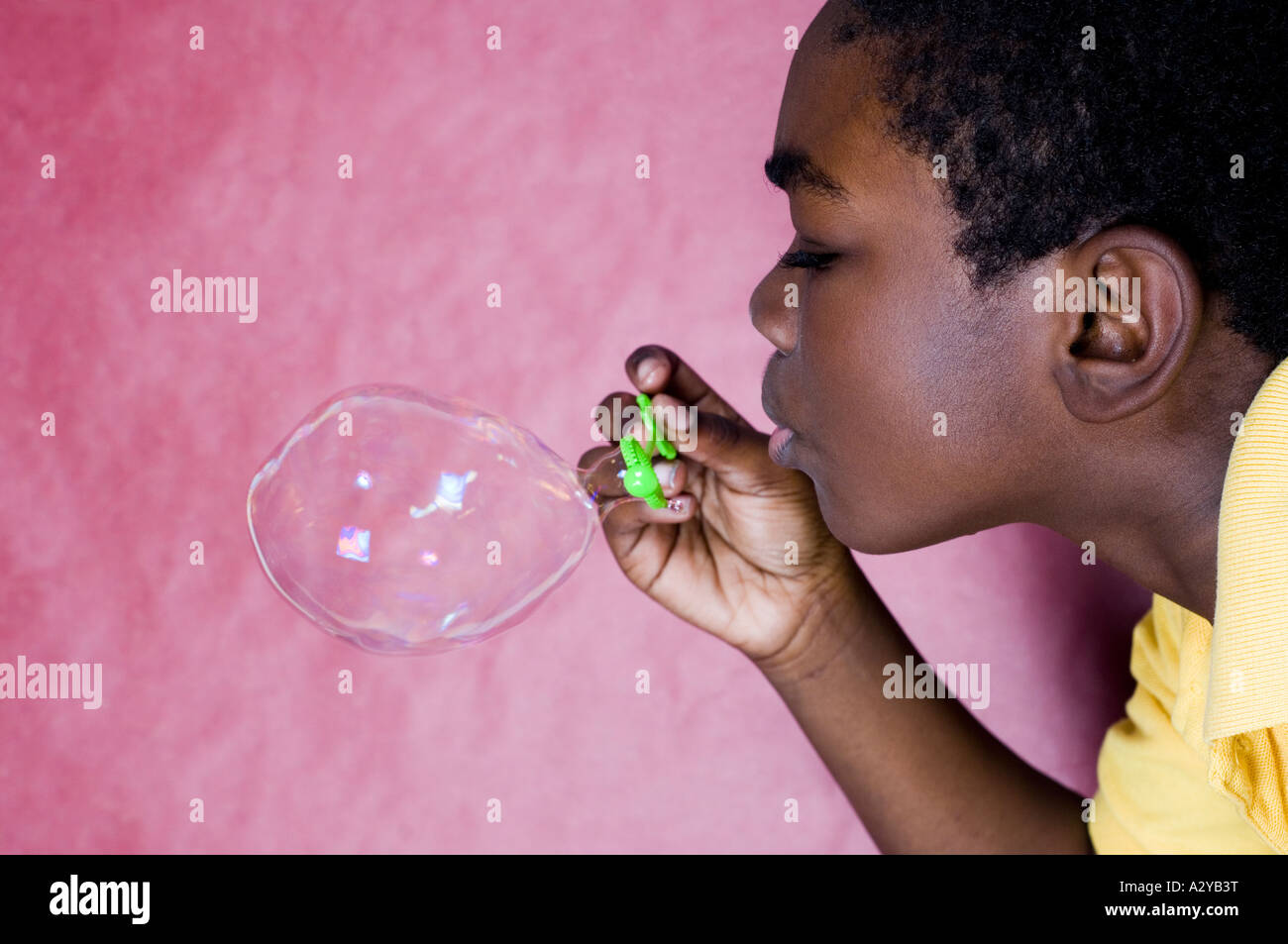 Boy blowing a bubble Stock Photo