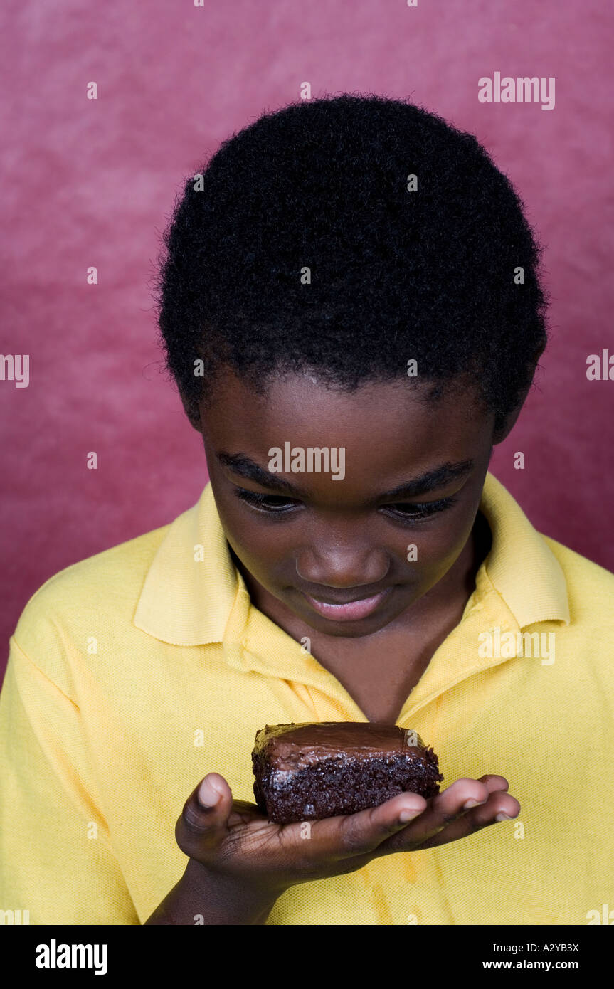Boy looking at chocolate cake Stock Photo