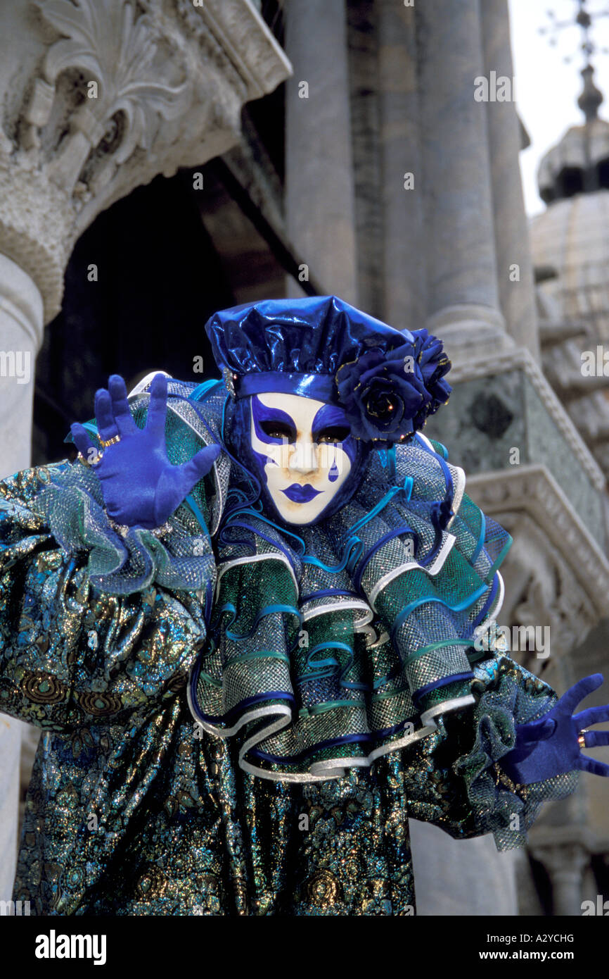 A Jester in Blue and Green Entertains in San Marco at Carnevale in Venice, Italy Stock Photo