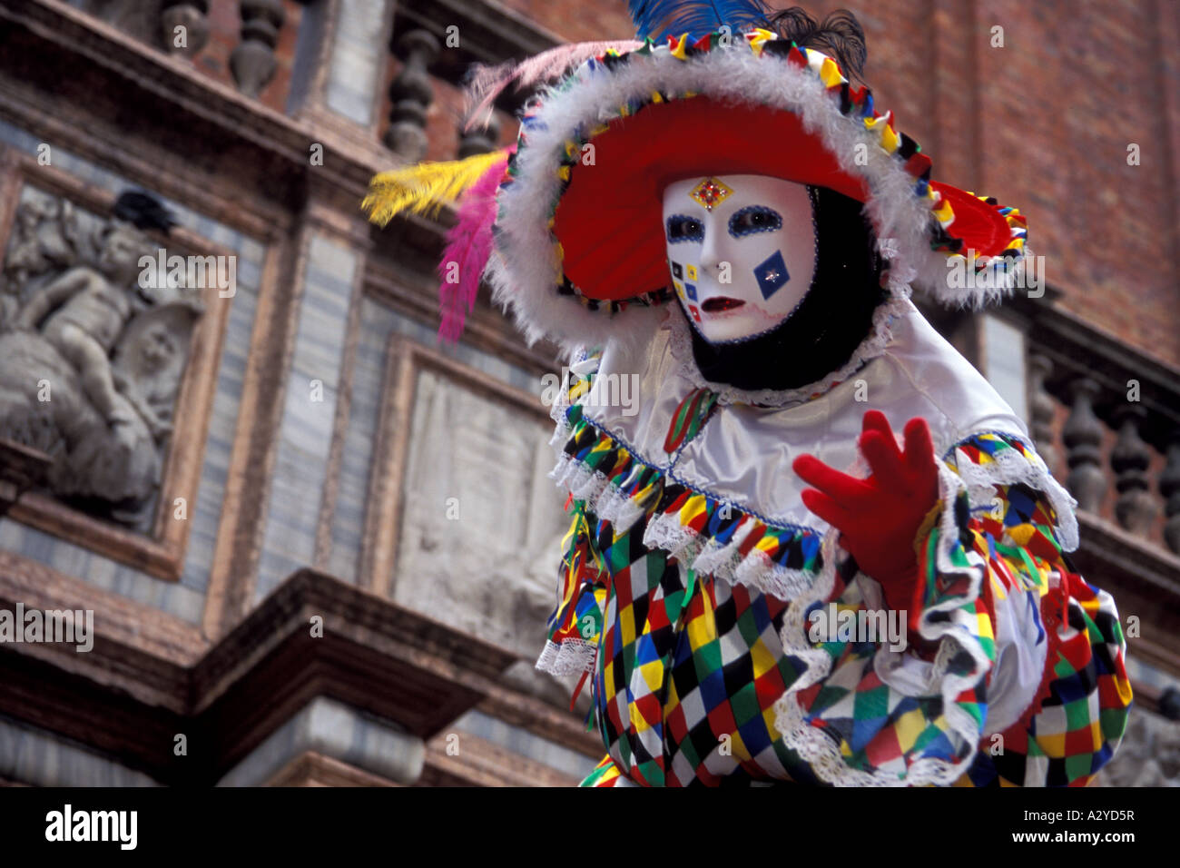 Colorful Harlequin Entertains at Carnevale in Venice, Italy Stock Photo