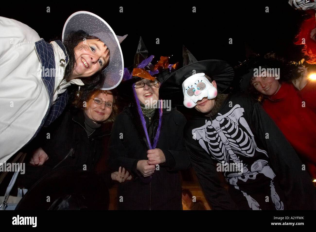 people in various costumes smile for camera Halloween Derry Ireland