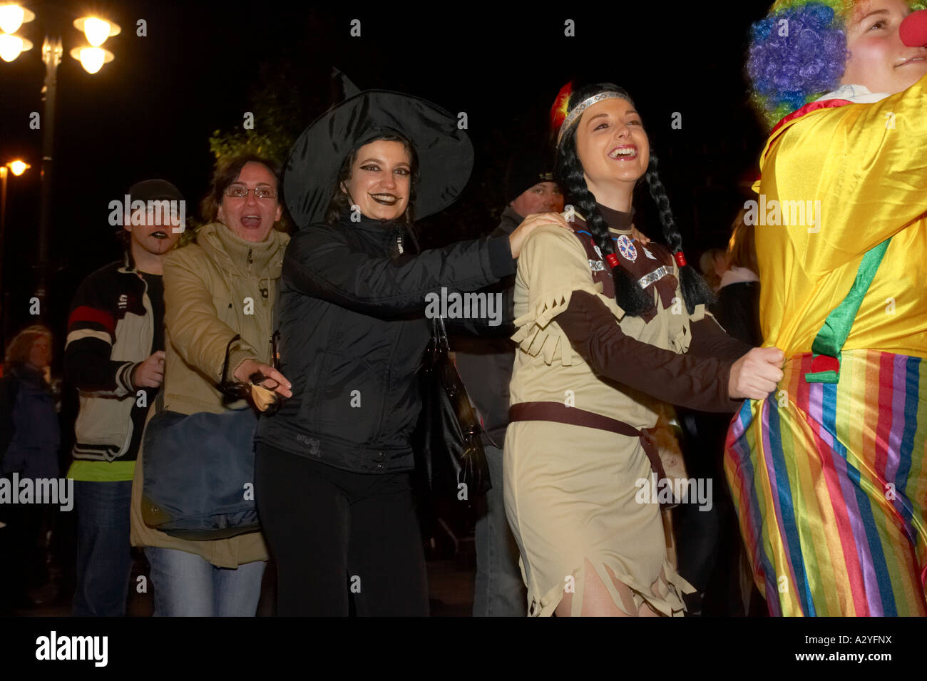 people in fancy dress do the conga dance through the crowd in guildhall