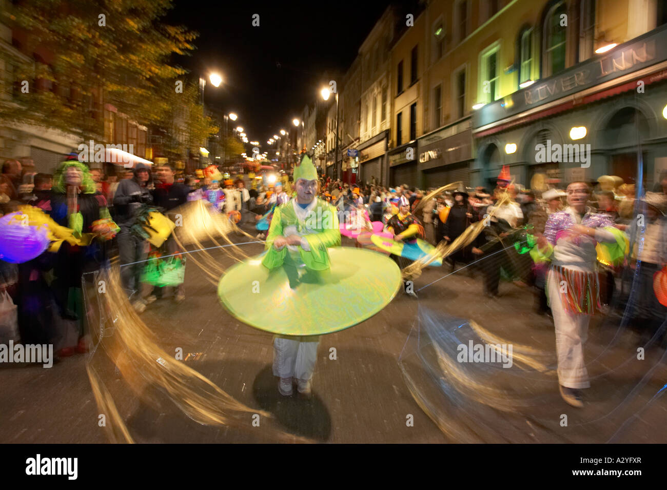 children in colourful costumes with streamers parade down shipquay
