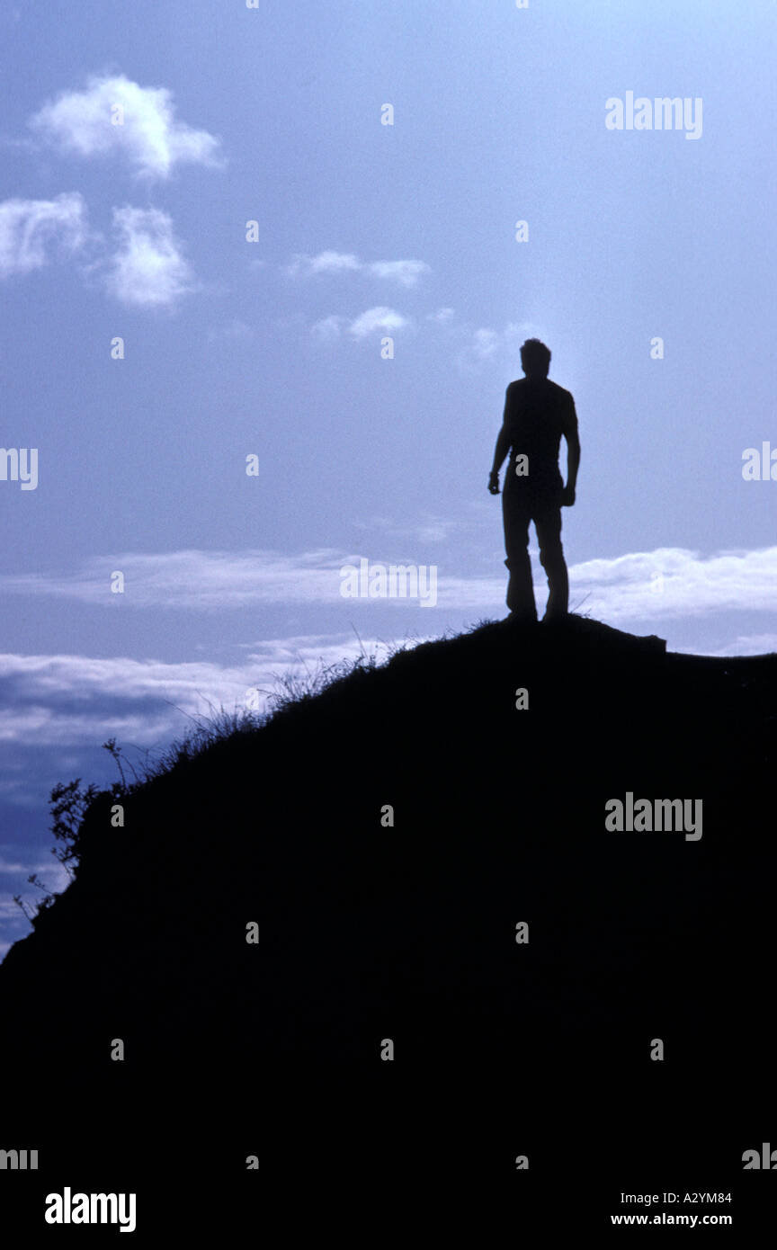 Young man looking out to sea from a hilltop on Canada West Coast Stock ...
