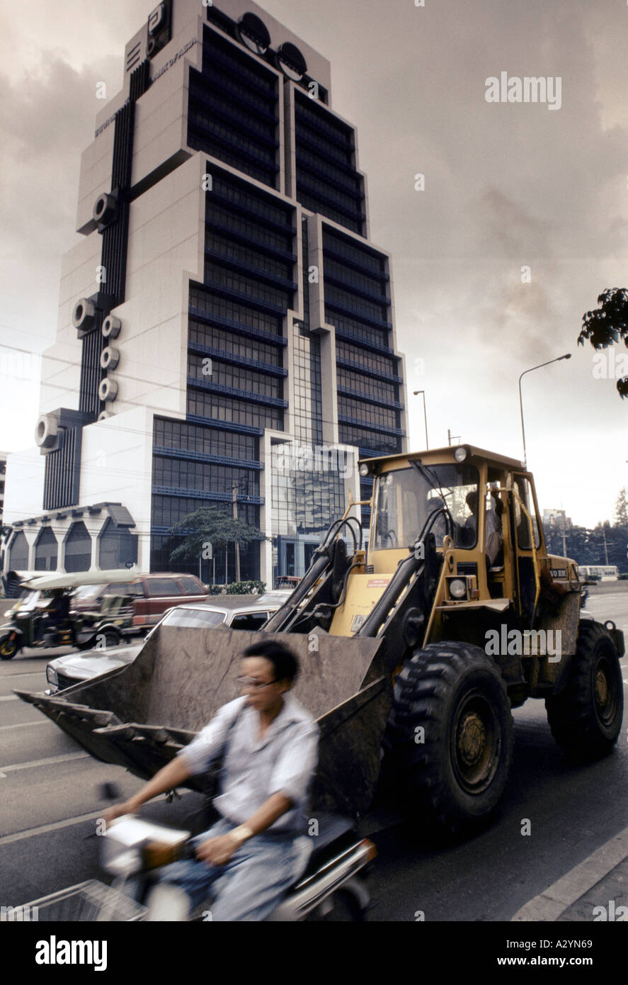 Robot office block in central Bangkok, with a yellow digger and a man ...