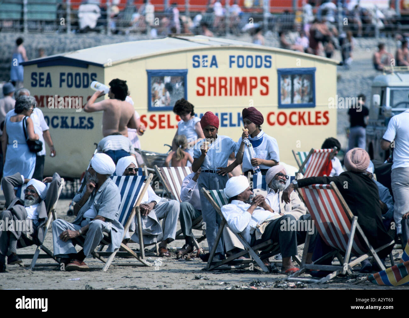 families in deck chairs on blackpool beach Stock Photo Alamy