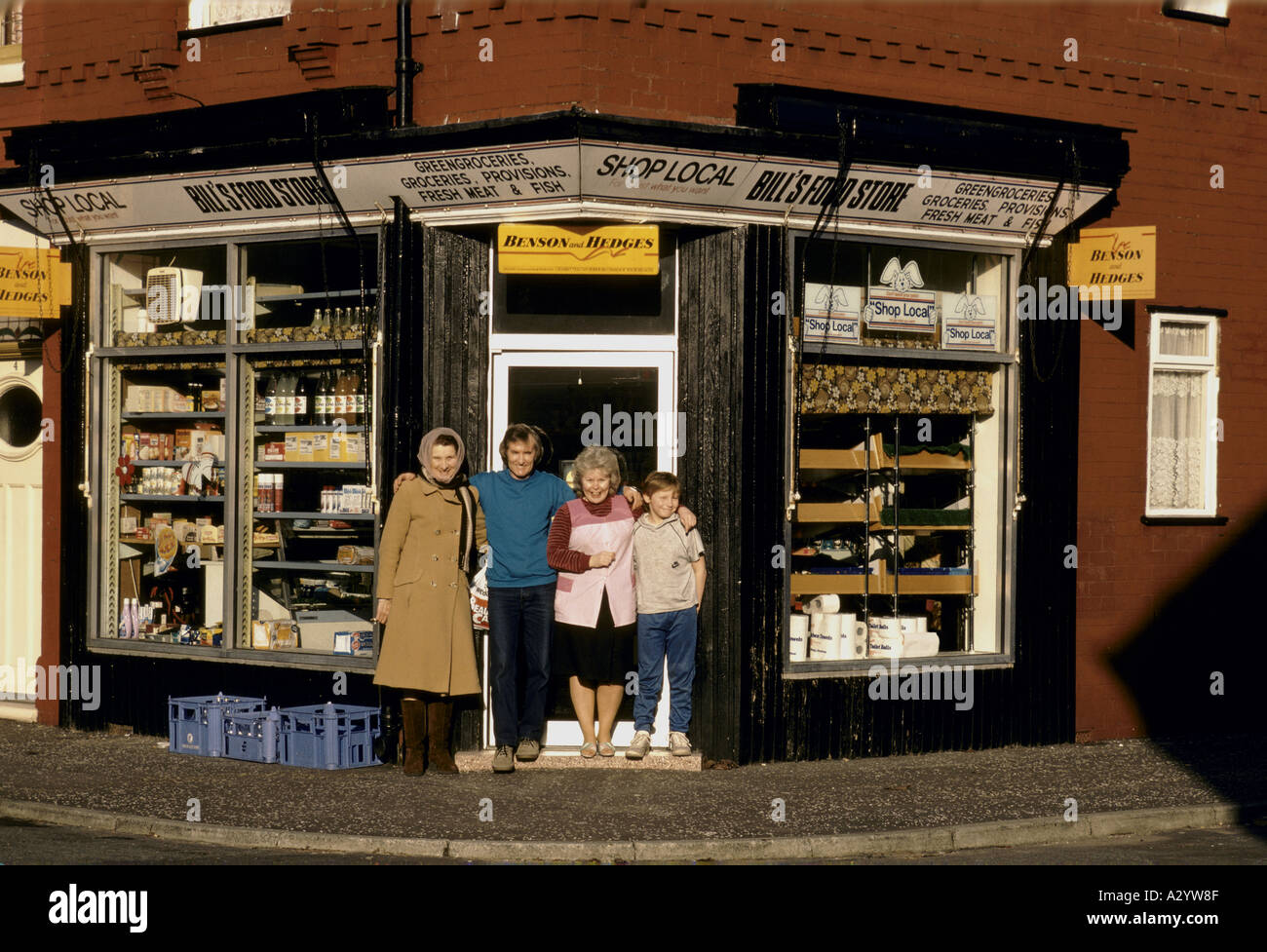 family outside grocery store in the UK Stock Photo