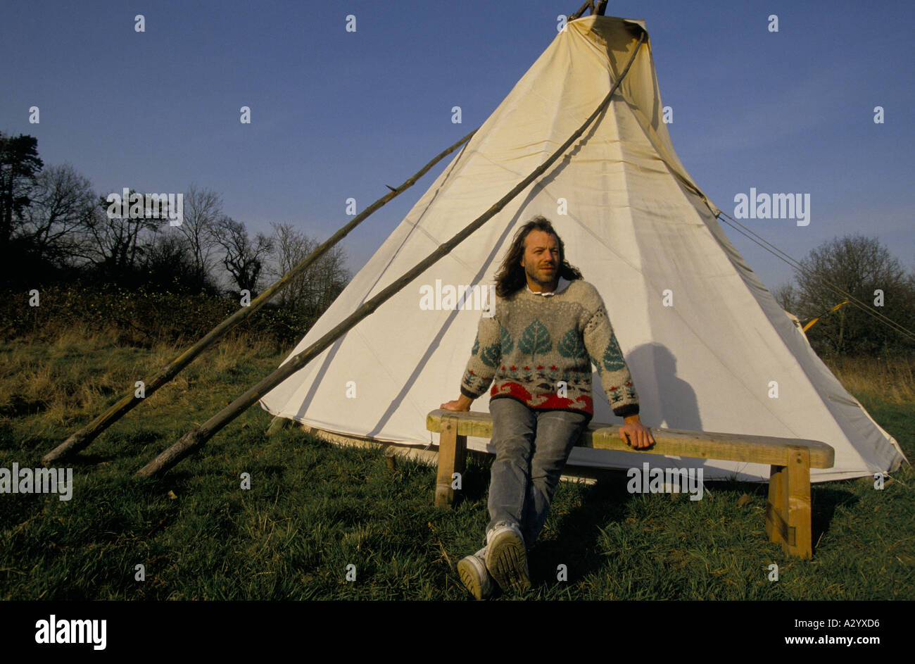 Bruce the woodwork teacher at Summerhill school sitting outside his teepee in the grounds of the scholl Stock Photo