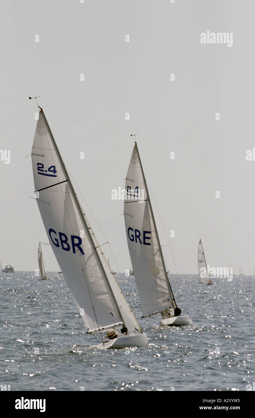 Allan Smith of Great Britain follows Stamatis Kalligeris of Greece in race 3 of the Mixed 2 4mR open category during the Athens Stock Photo