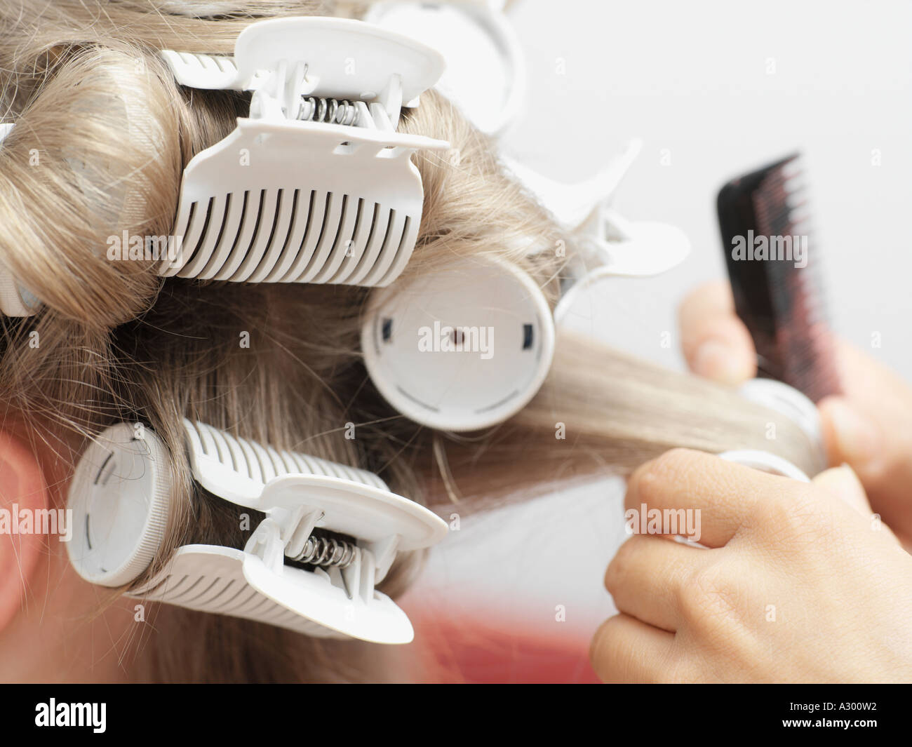 Hairdresser putting in curlers Stock Photo