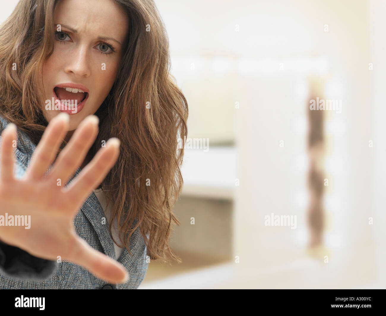 Young woman holding up hand Stock Photo - Alamy