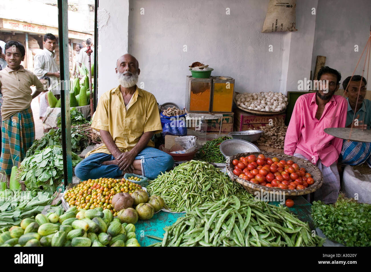 Vendors at an open air market selling vegetables in Dhaka Bangladesh