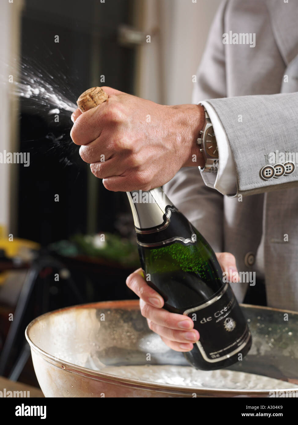 Man opening champagne bottle Stock Photo