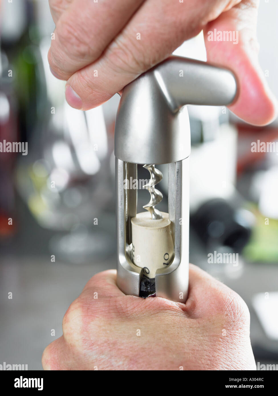 Hand using corkscrew Stock Photo Alamy