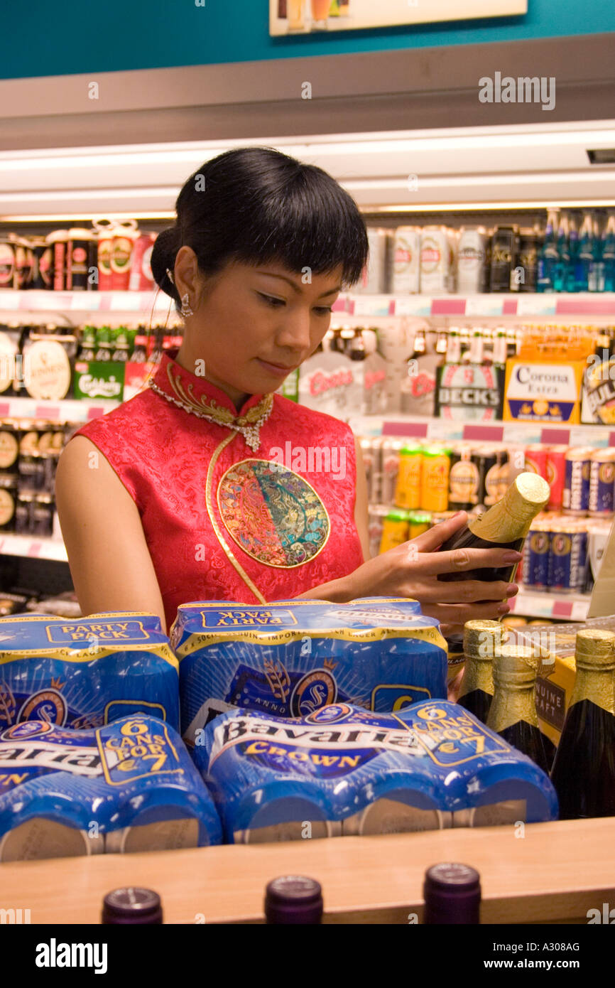 Chinese woman in traditional dress shopping in supermarket store Stock Photo