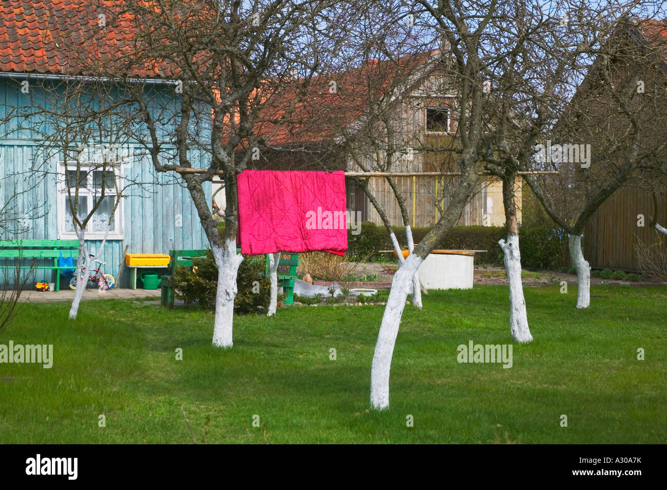 Dyring laundry in a house courtyard Neringa Curonian Spit Lithuania Stock Photo