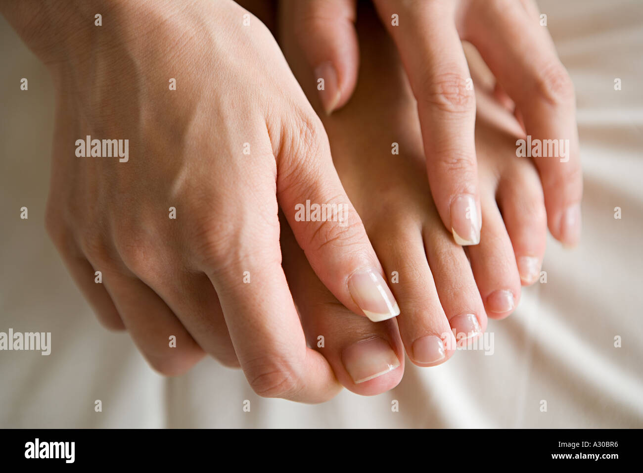 Hands massaging feet Stock Photo