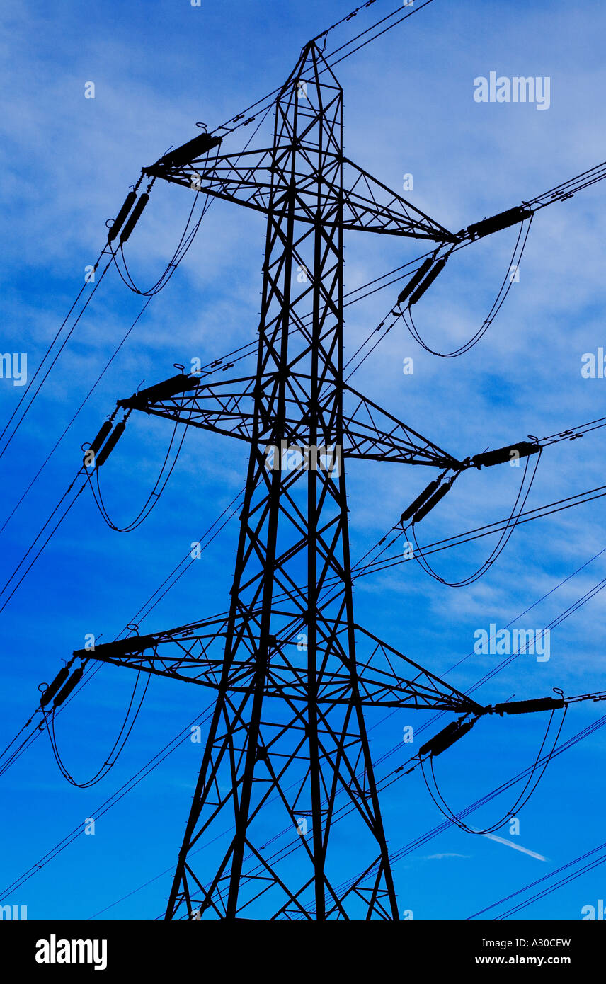 Electricity pylon silhouetted against a vivid blue sky Stock Photo - Alamy