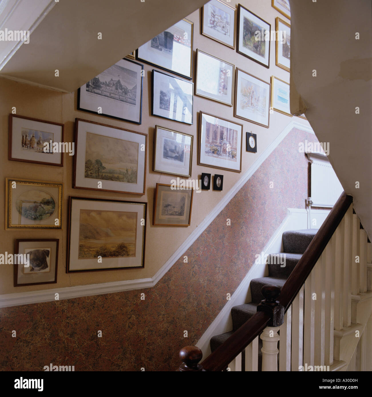 Staircase and wall of pictures and artwork Stock Photo