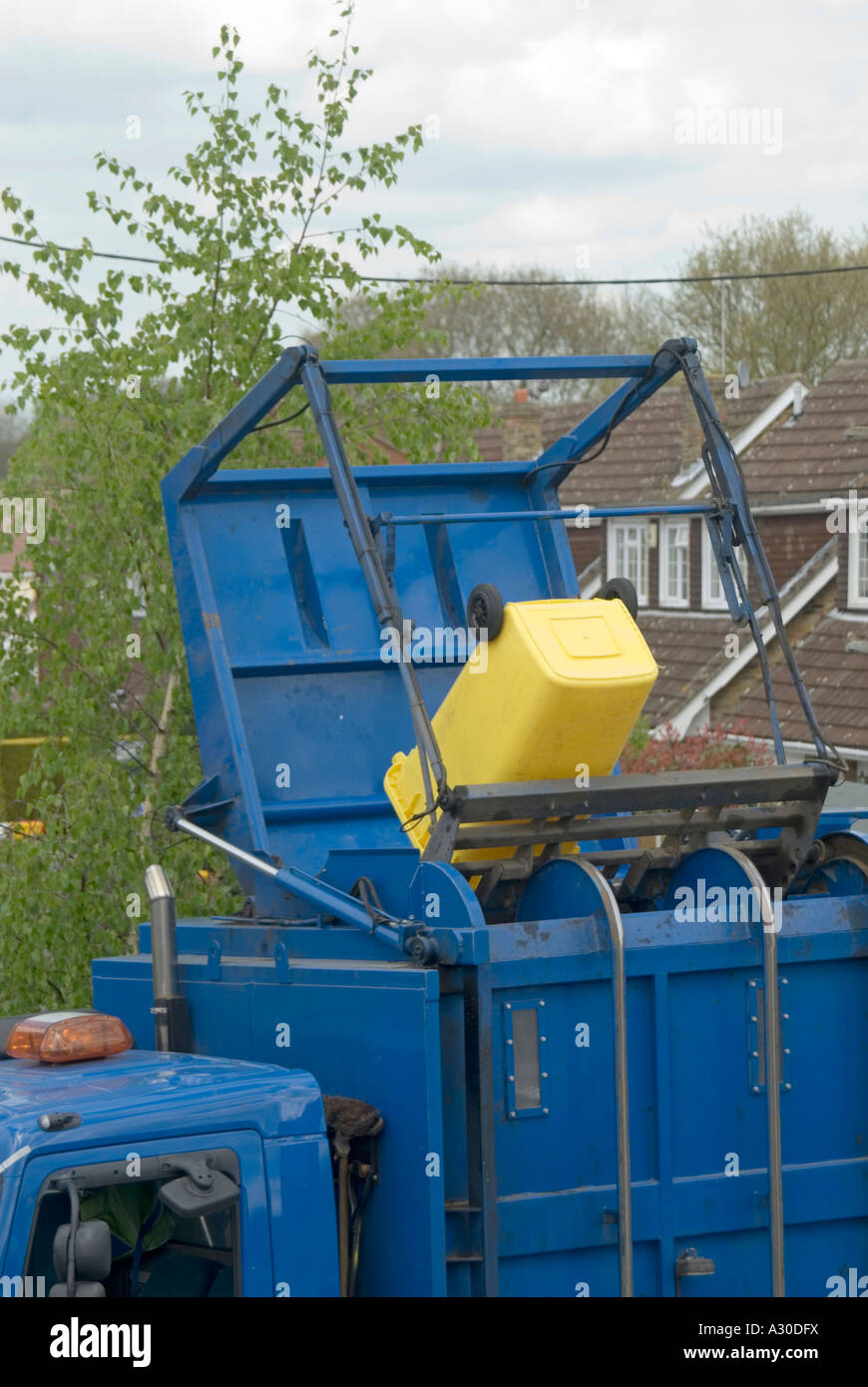 Local authority dust cart lorry with wheelie bin raised and emptying