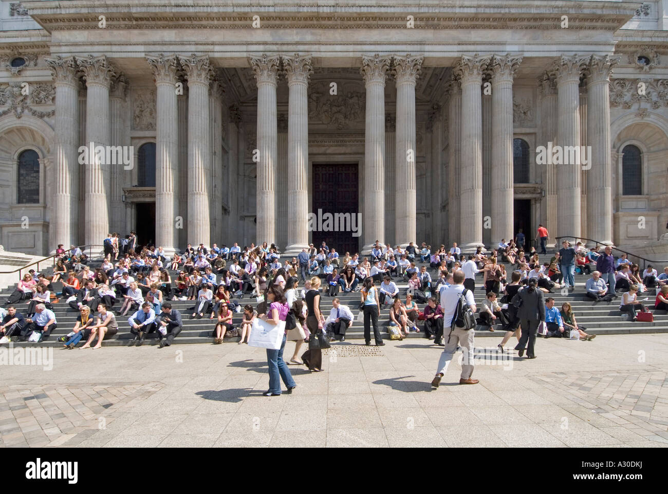 St Pauls cathedral entrance steps crowded with office workers and tourists lunch break time on a hot summers day Stock Photo