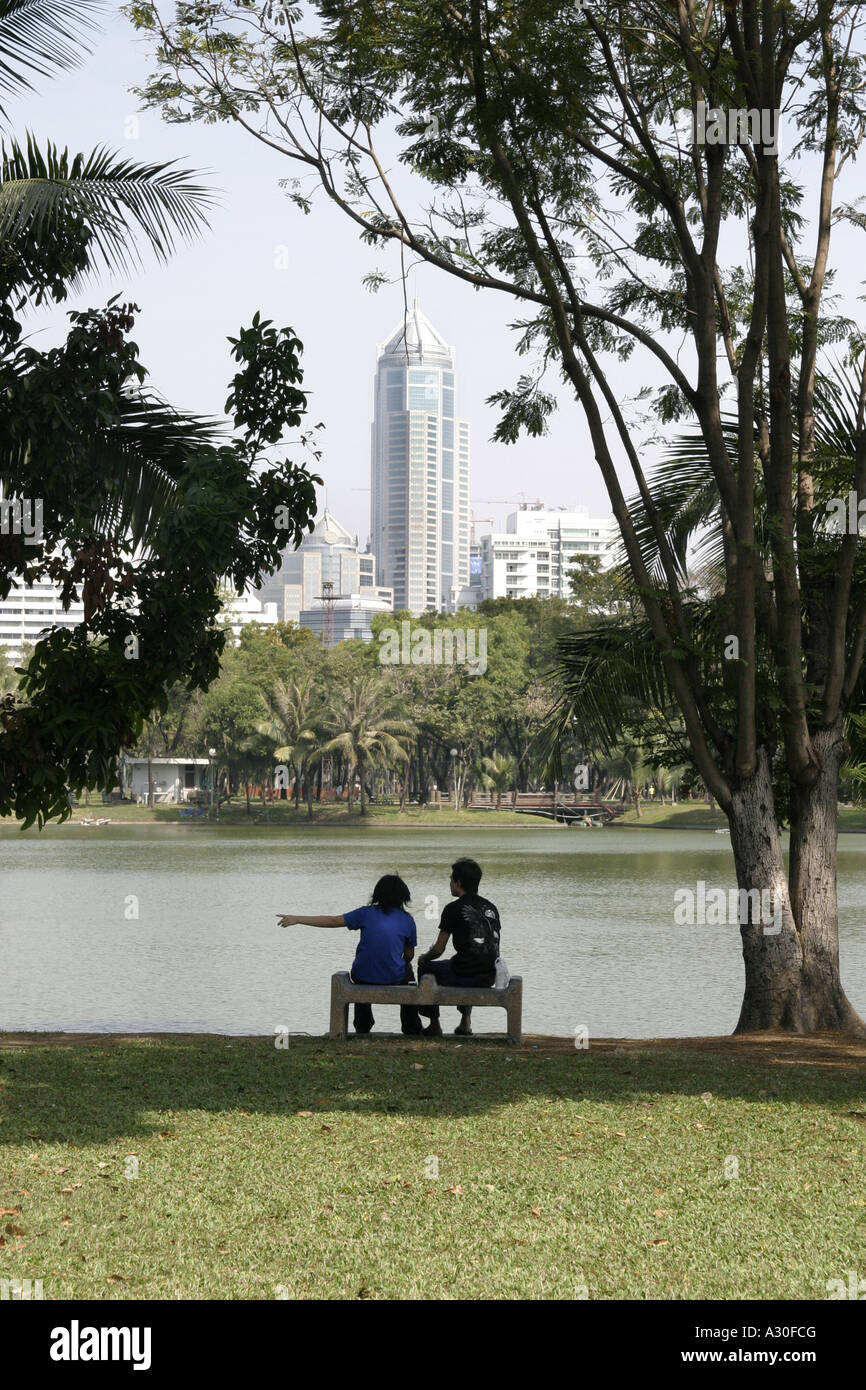 'Couple sitting by the Boating Lake in Lumpini Park Bangkok Thailand' Stock Photo
